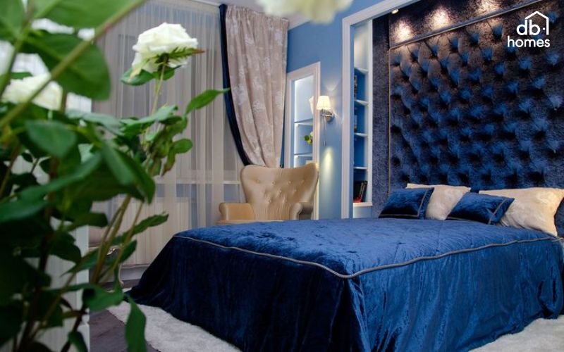 Ánh sáng kết hợp hài hòa giúp làm nổi bật và cân bằng màu xanh nước biển trong phòng ngủ